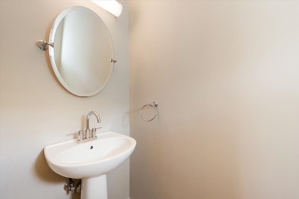 6 Bates Street, Unit A Devens, MA 01434 - Photo 25 of 41 a bathroom with a sink a mirror and a toilet