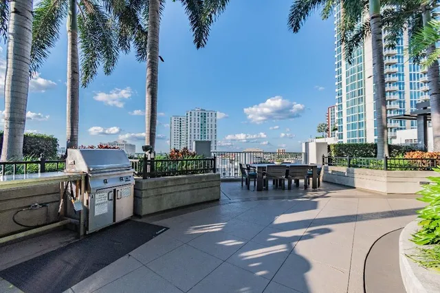 a view of a patio with couches table and chairs and potted plants