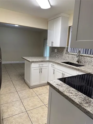 a kitchen with stainless steel appliances a sink stove and cabinets