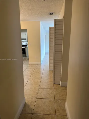 a view of an empty room and a window