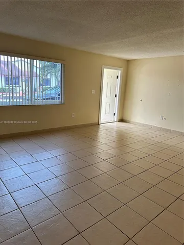 a view of an empty room and a window