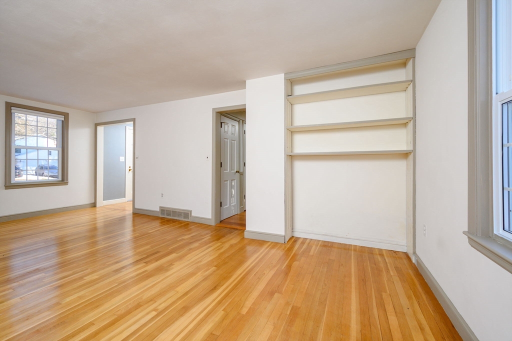 15 Autumn Circle Hingham, MA 02043 - Photo 13 of 38 a view of an empty room with wooden floor and a window
