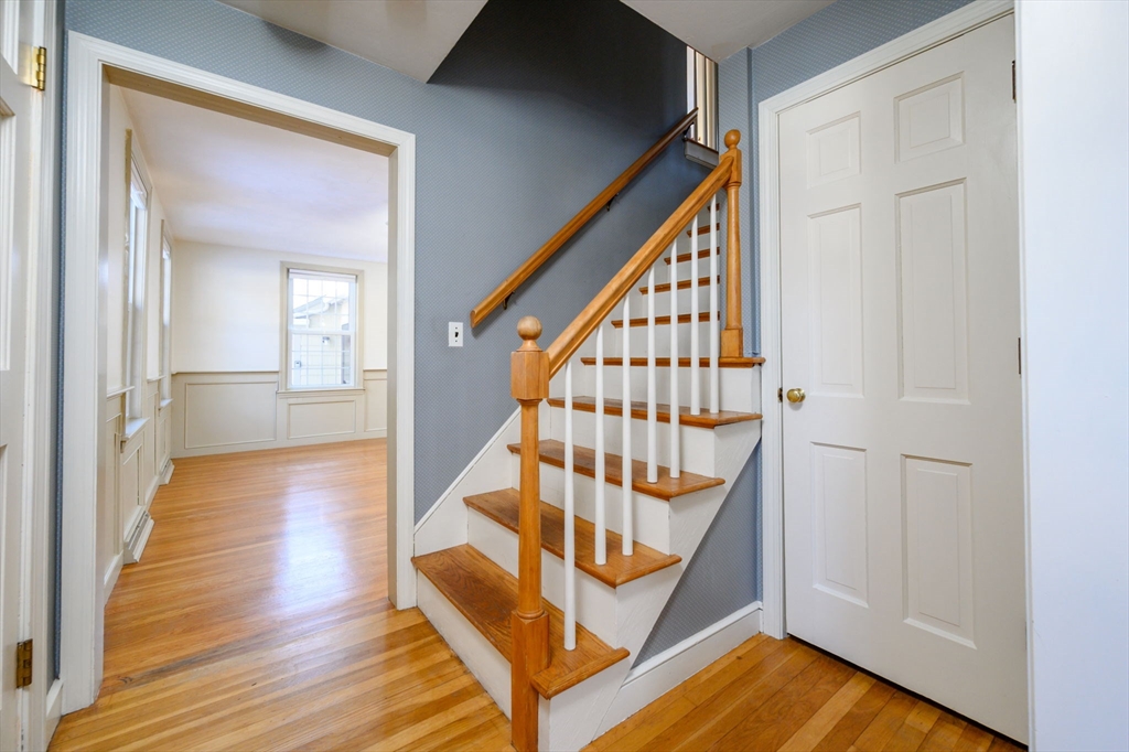 15 Autumn Circle Hingham, MA 02043 - Photo 14 of 38 a view of a hallway with wooden floor and staircase
