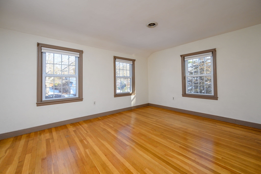 15 Autumn Circle Hingham, MA 02043 - Photo 15 of 38 a view of an empty room with window and wooden floor