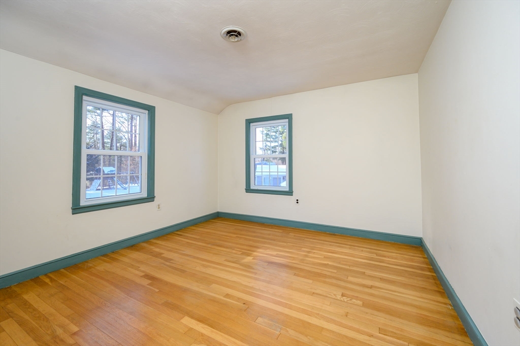 15 Autumn Circle Hingham, MA 02043 - Photo 20 of 38 a view of an empty room with wooden floor and a window