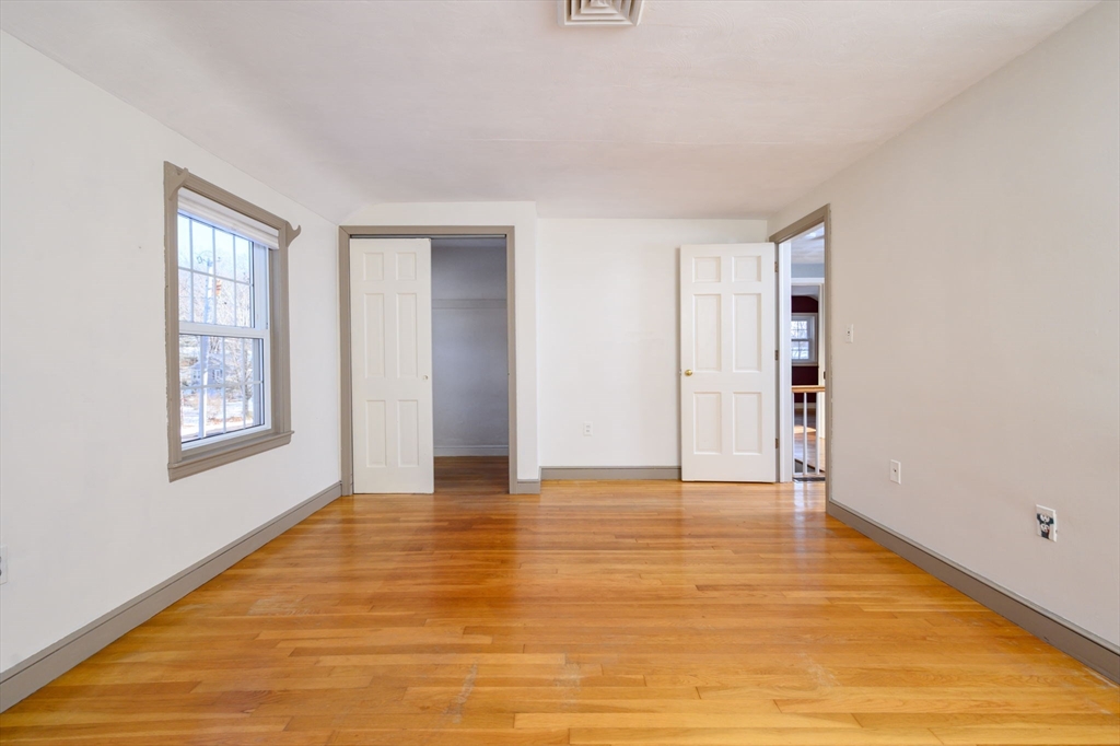 15 Autumn Circle Hingham, MA 02043 - Photo 22 of 38 a view of an empty room with wooden floor and a window
