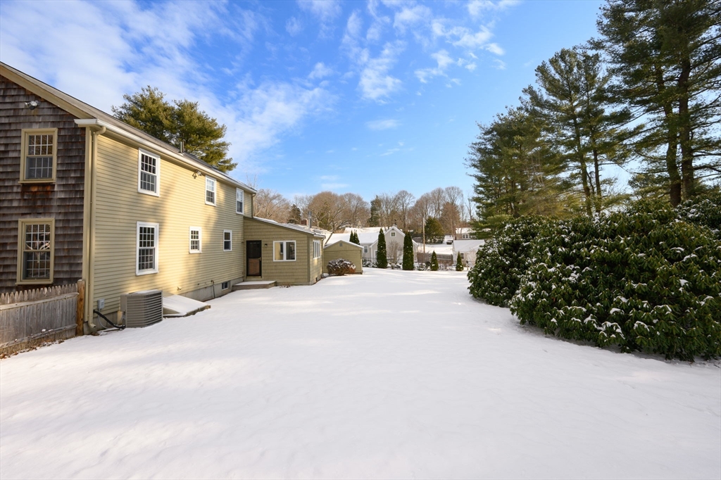 15 Autumn Circle Hingham, MA 02043 - Photo 31 of 38 a front view of a house with a yard and garage