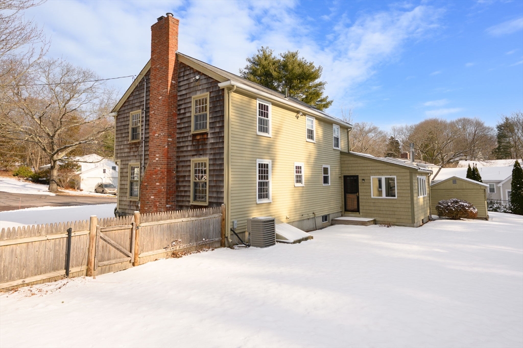 15 Autumn Circle Hingham, MA 02043 - Photo 32 of 38 a front view of a house with a yard covered in snow