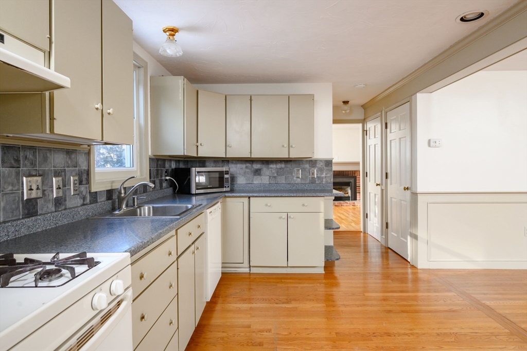 15 Autumn Circle Hingham, MA 02043 - Photo 4 of 38 a kitchen with stainless steel appliances granite countertop a stove a sink and white cabinets
