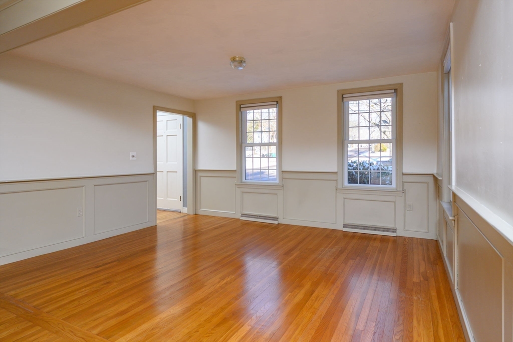 15 Autumn Circle Hingham, MA 02043 - Photo 8 of 38 an empty room with wooden floor and windows