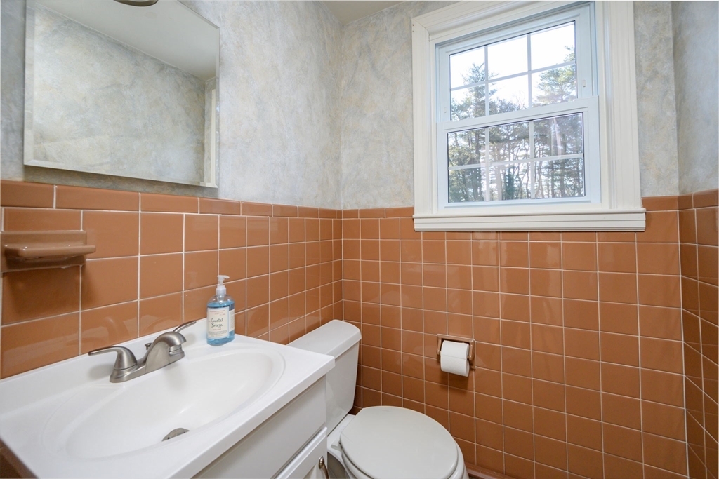 15 Autumn Circle Hingham, MA 02043 - Photo 9 of 38 a bathroom with a sink a toilet and a mirror