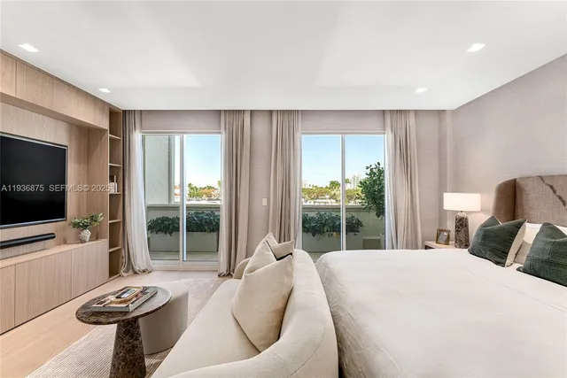 a bedroom with a bed and glass window