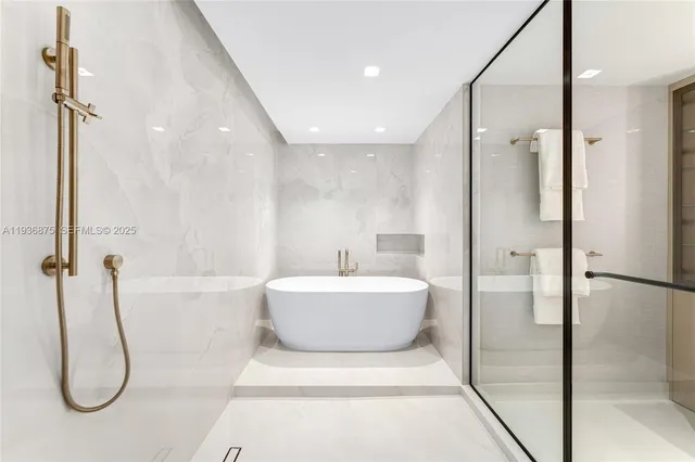 a bathroom with a tub and a shower