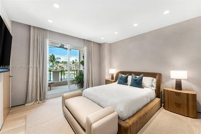 a bedroom with a large bed and a flat screen tv