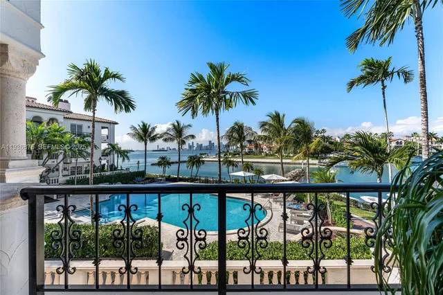 a view of a palm tree from a balcony