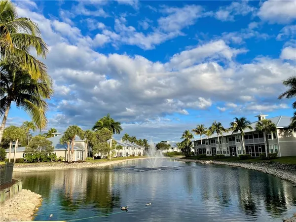 a view of residential houses with outdoor space and lake view