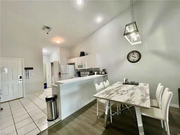 a kitchen with stainless steel appliances kitchen island a refrigerator and a stove top oven