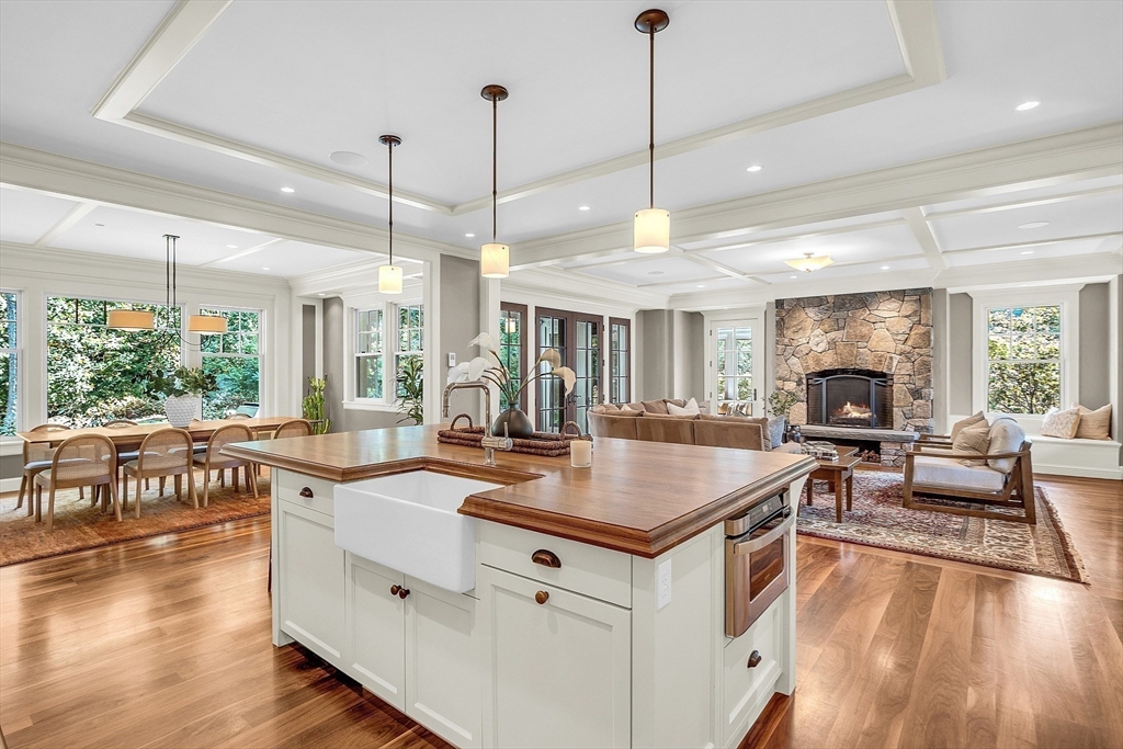 247 Independence Road Concord, MA 01742 - Photo 11 of 42 a kitchen with a stove center island wooden floor and living room view