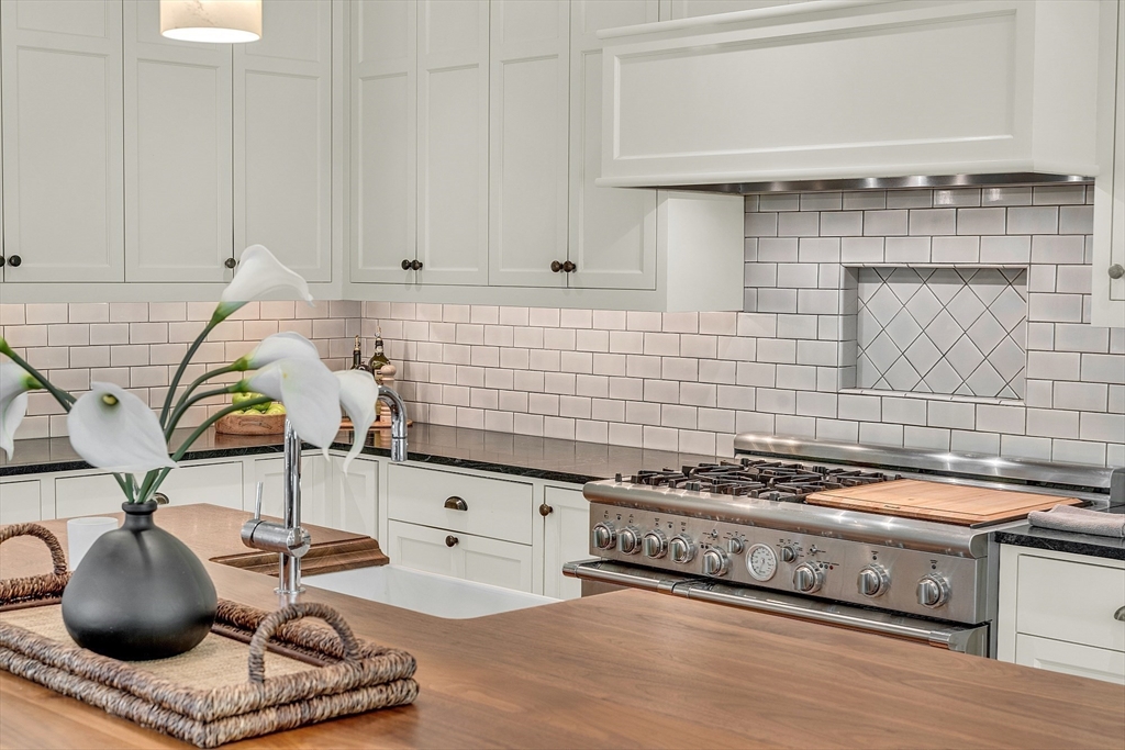 247 Independence Road Concord, MA 01742 - Photo 12 of 42 a kitchen with stainless steel appliances granite countertop a sink a stove and cabinets