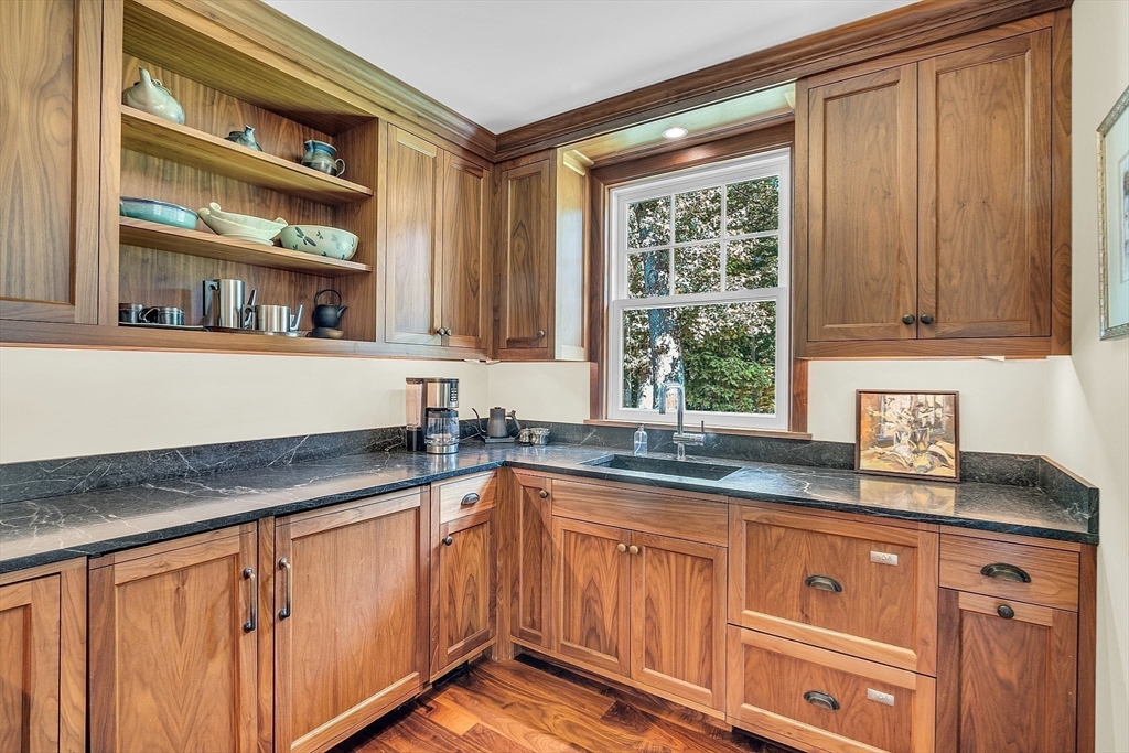 247 Independence Road Concord, MA 01742 - Photo 13 of 42 a kitchen with granite countertop stainless steel appliances a sink window and cabinets