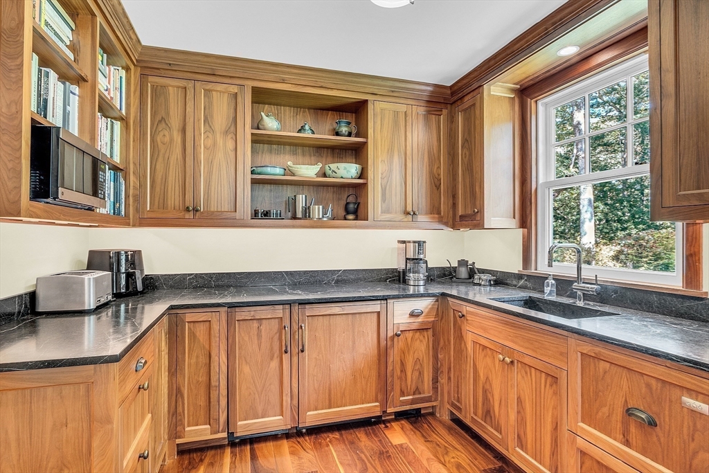 247 Independence Road Concord, MA 01742 - Photo 14 of 42 a kitchen with granite countertop a sink and cabinets