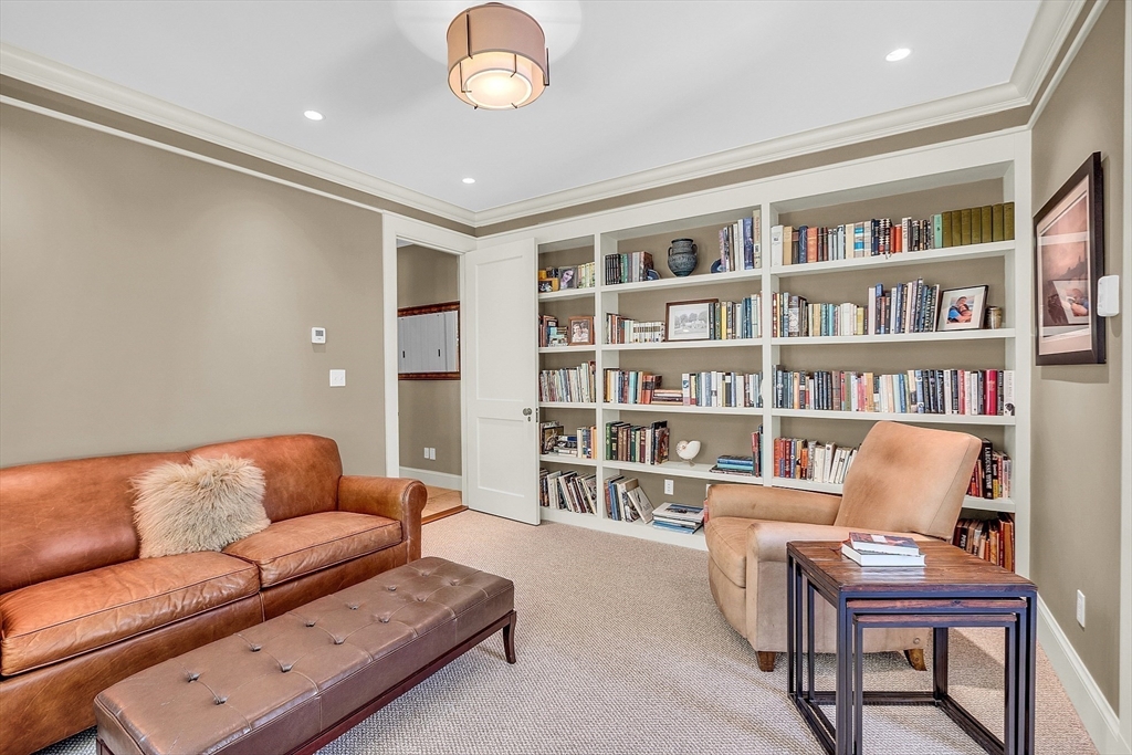 247 Independence Road Concord, MA 01742 - Photo 22 of 42 a living room with furniture and a book shelf
