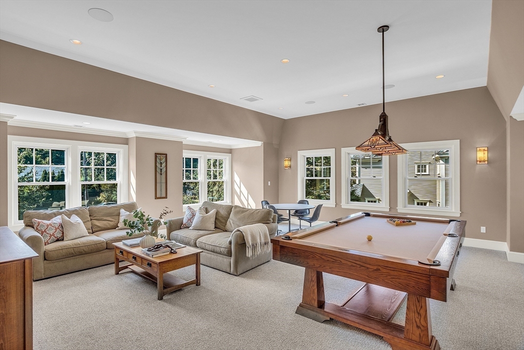 247 Independence Road Concord, MA 01742 - Photo 24 of 42 a living room with furniture a window and a chandelier
