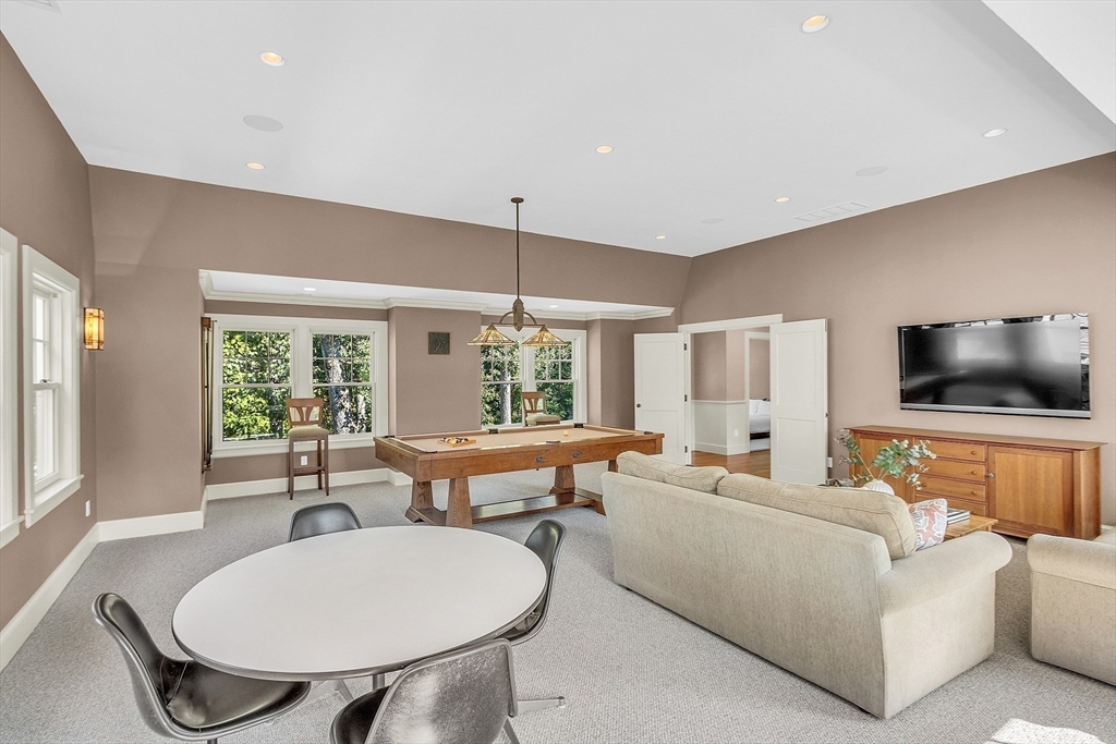 247 Independence Road Concord, MA 01742 - Photo 25 of 42 a living room with furniture a flat screen tv and a large window