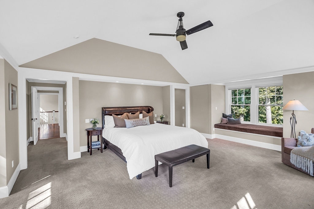 247 Independence Road Concord, MA 01742 - Photo 26 of 42 a bedroom with a bed and a chandelier