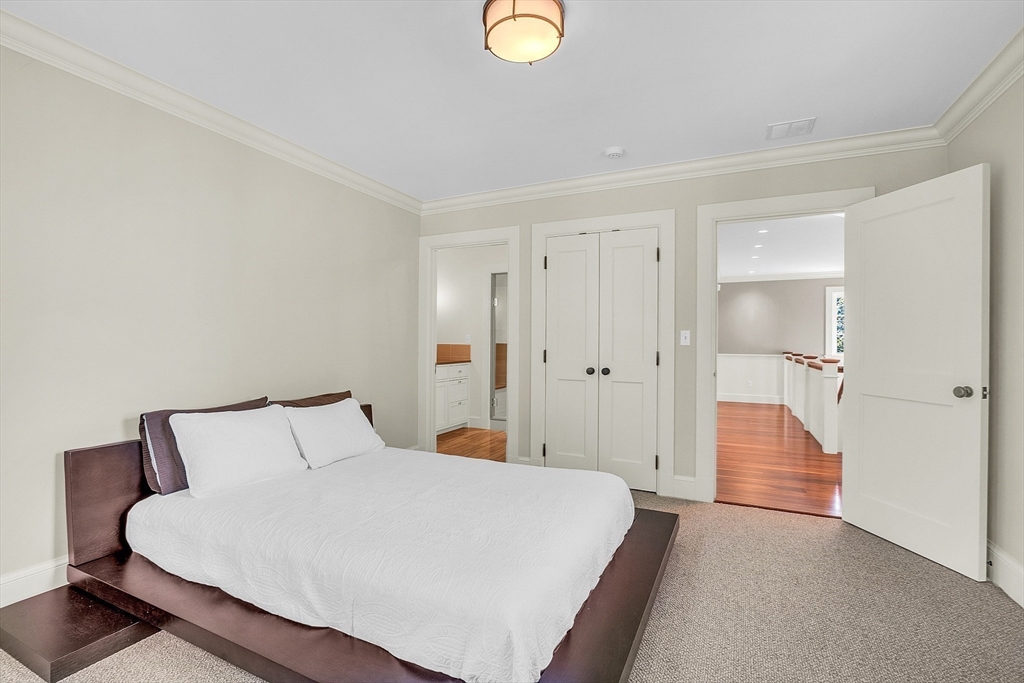 247 Independence Road Concord, MA 01742 - Photo 35 of 42 a bedroom with a bed and a lamp