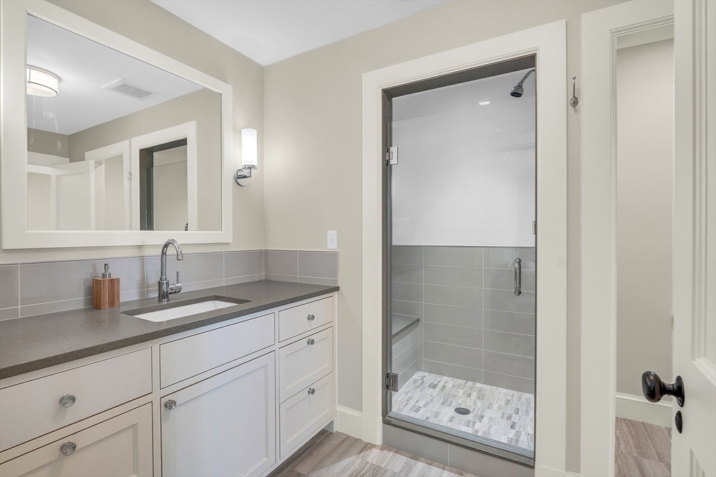 247 Independence Road Concord, MA 01742 - Photo 36 of 42 a bathroom with a shower sink and mirror