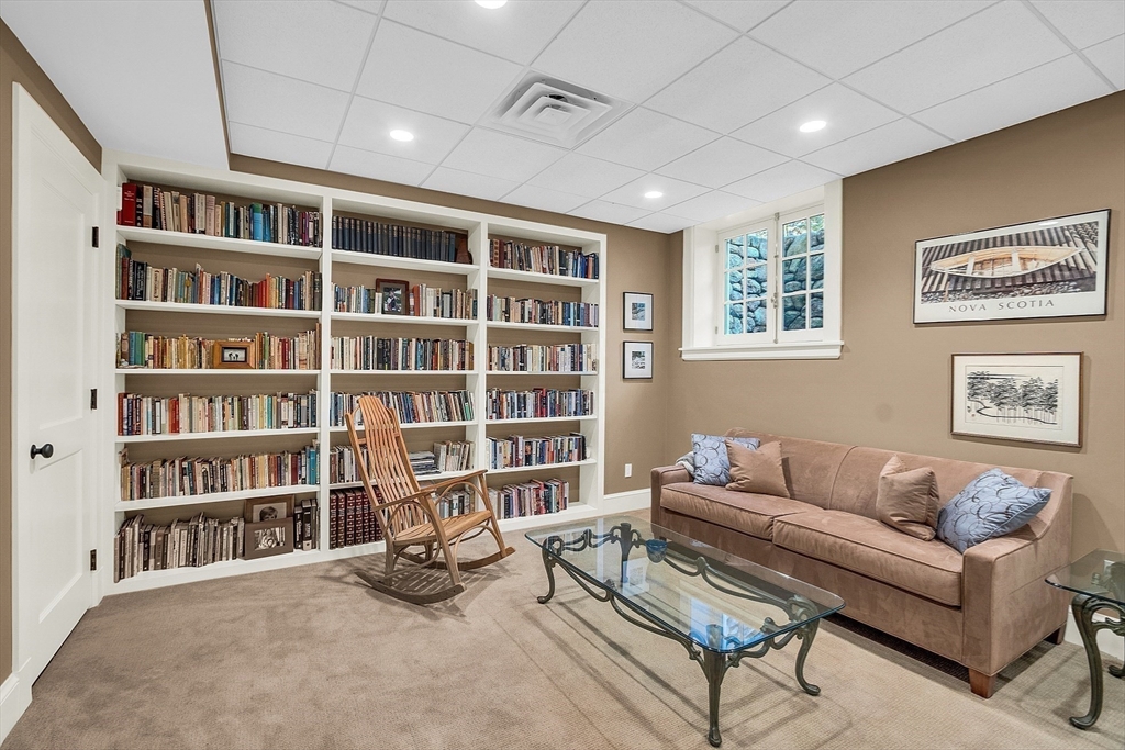 247 Independence Road Concord, MA 01742 - Photo 37 of 42 a living room with furniture and a book shelf