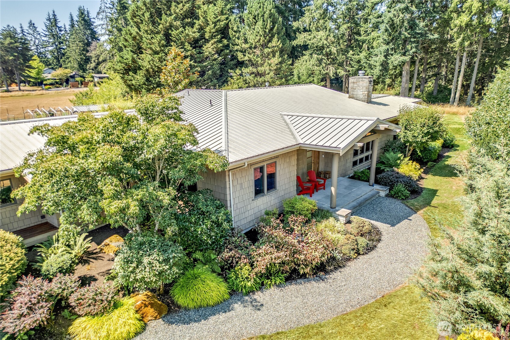 7870 Northeast Koura Farm Drive Bainbridge Island, WA 98110 - Photo 1 of 39 an aerial view of a house with a yard and potted plants