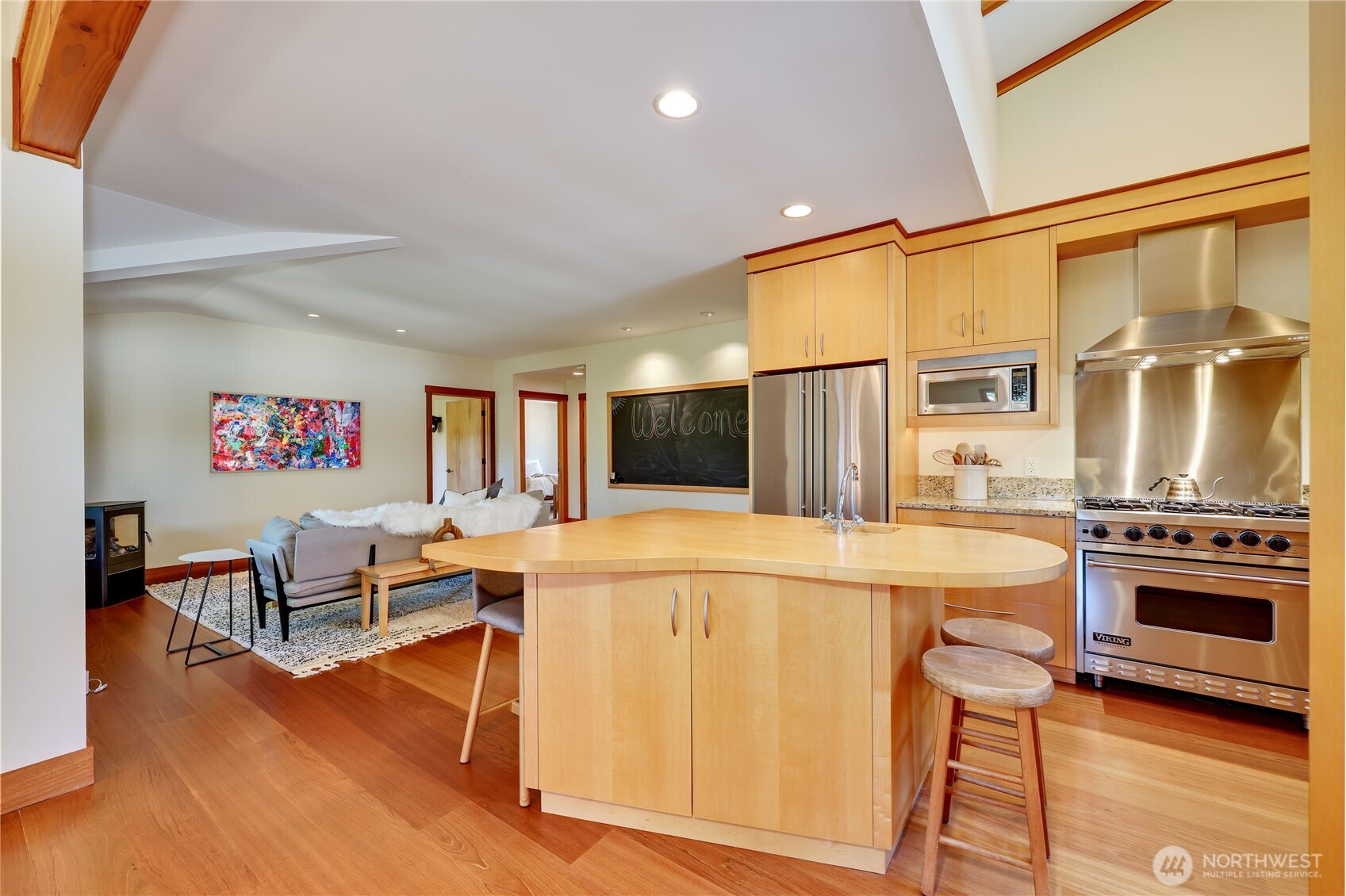 7870 Northeast Koura Farm Drive Bainbridge Island, WA 98110 - Photo 11 of 39 a living room with stainless steel appliances furniture and a kitchen view