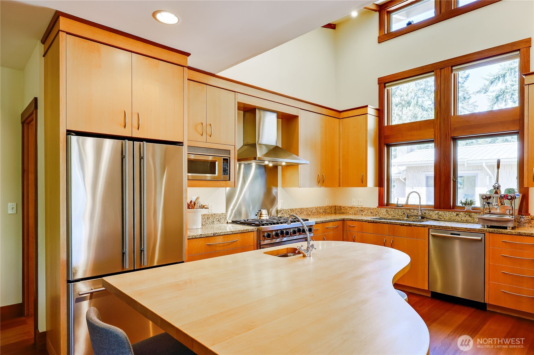 7870 Northeast Koura Farm Drive Bainbridge Island, WA 98110 - Photo 12 of 39 a kitchen with stainless steel appliances granite countertop a sink and a refrigerator