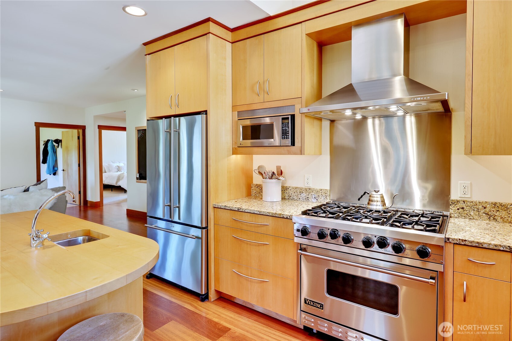 7870 Northeast Koura Farm Drive Bainbridge Island, WA 98110 - Photo 13 of 39 a kitchen with stainless steel appliances granite countertop a stove a sink and a refrigerator