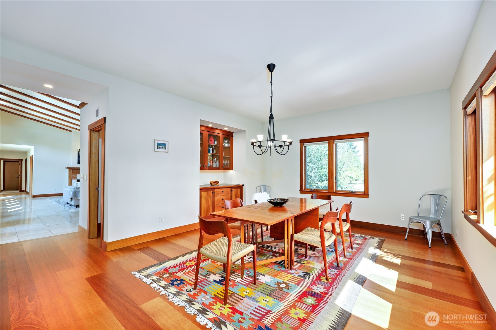 7870 Northeast Koura Farm Drive Bainbridge Island, WA 98110 - Photo 15 of 39 a view of a dining room with furniture window and wooden floor
