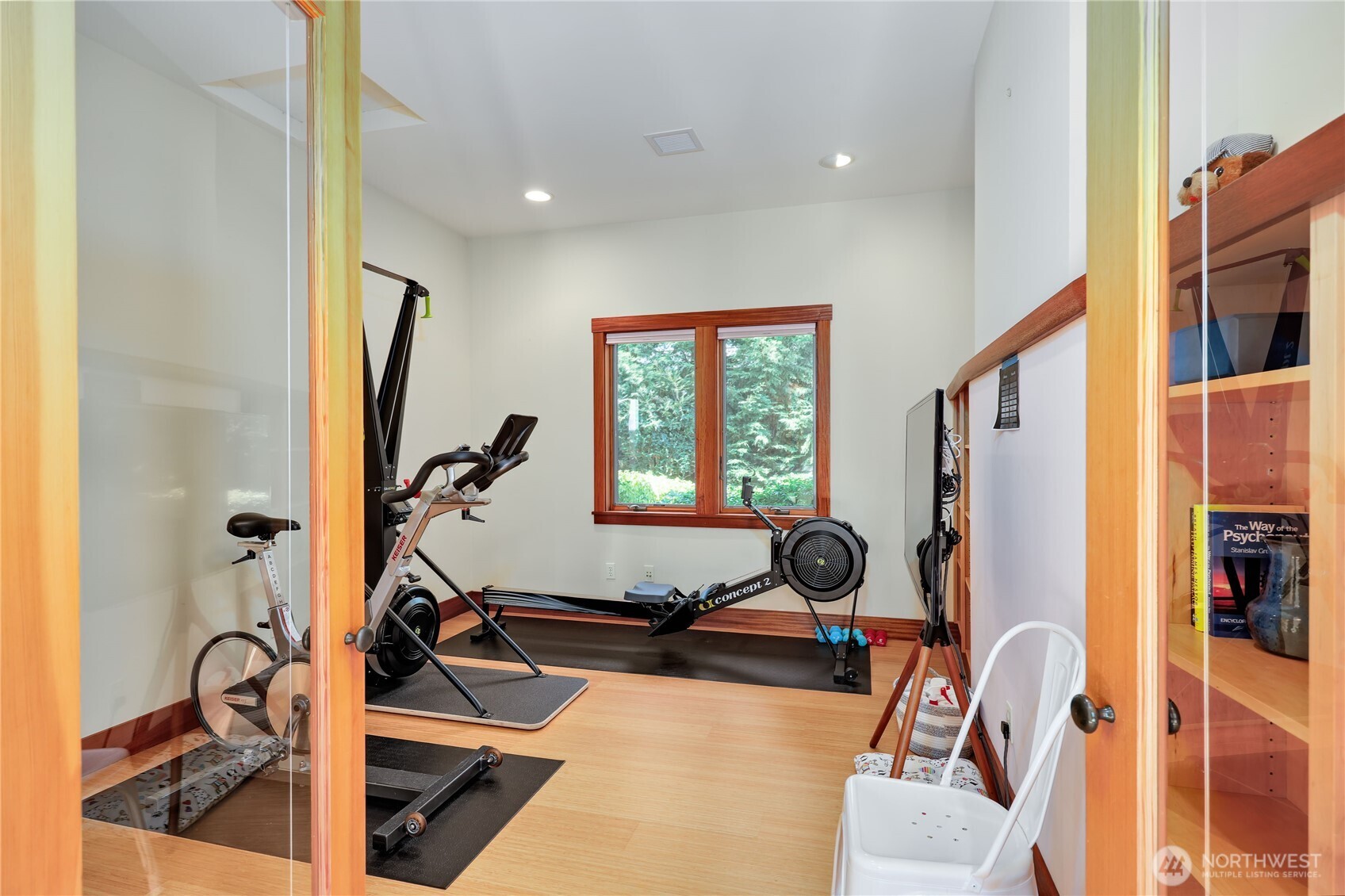 7870 Northeast Koura Farm Drive Bainbridge Island, WA 98110 - Photo 21 of 39 a room with gym equipment and windows