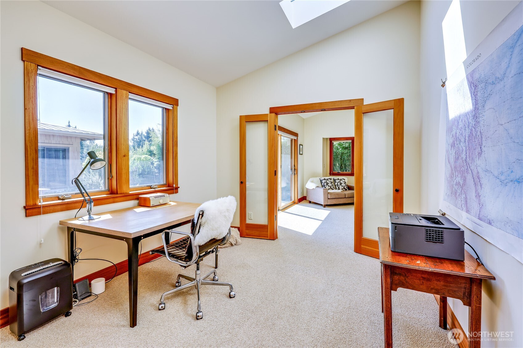 7870 Northeast Koura Farm Drive Bainbridge Island, WA 98110 - Photo 22 of 39 a living room with furniture a table and next to a window