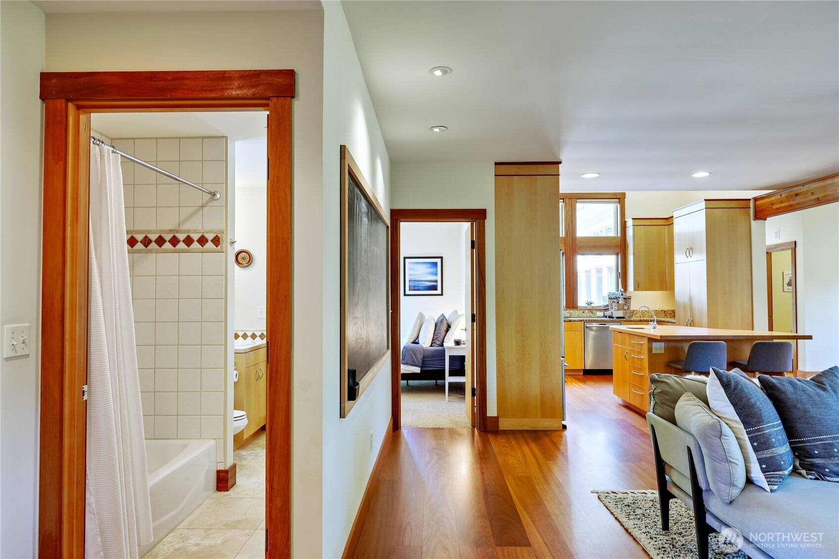7870 Northeast Koura Farm Drive Bainbridge Island, WA 98110 - Photo 28 of 39 a view of a hallway with furniture and wooden floor