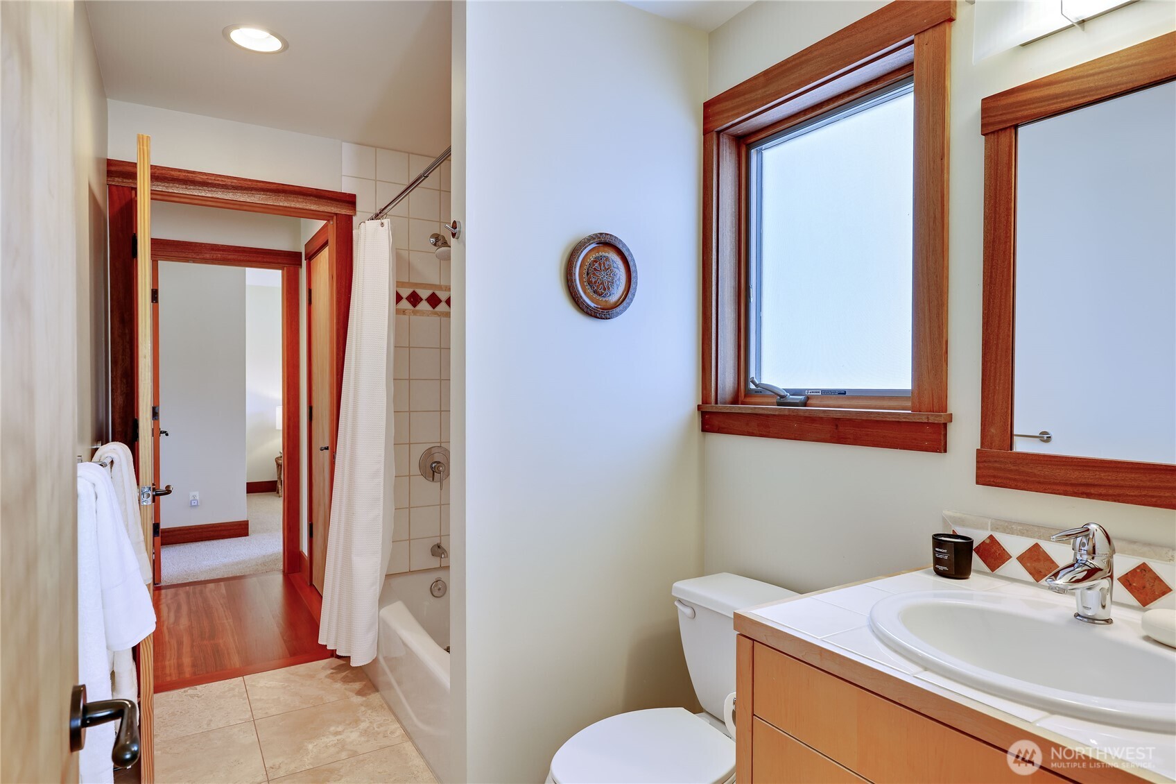 7870 Northeast Koura Farm Drive Bainbridge Island, WA 98110 - Photo 30 of 39 a bathroom with a sink a toilet and shower