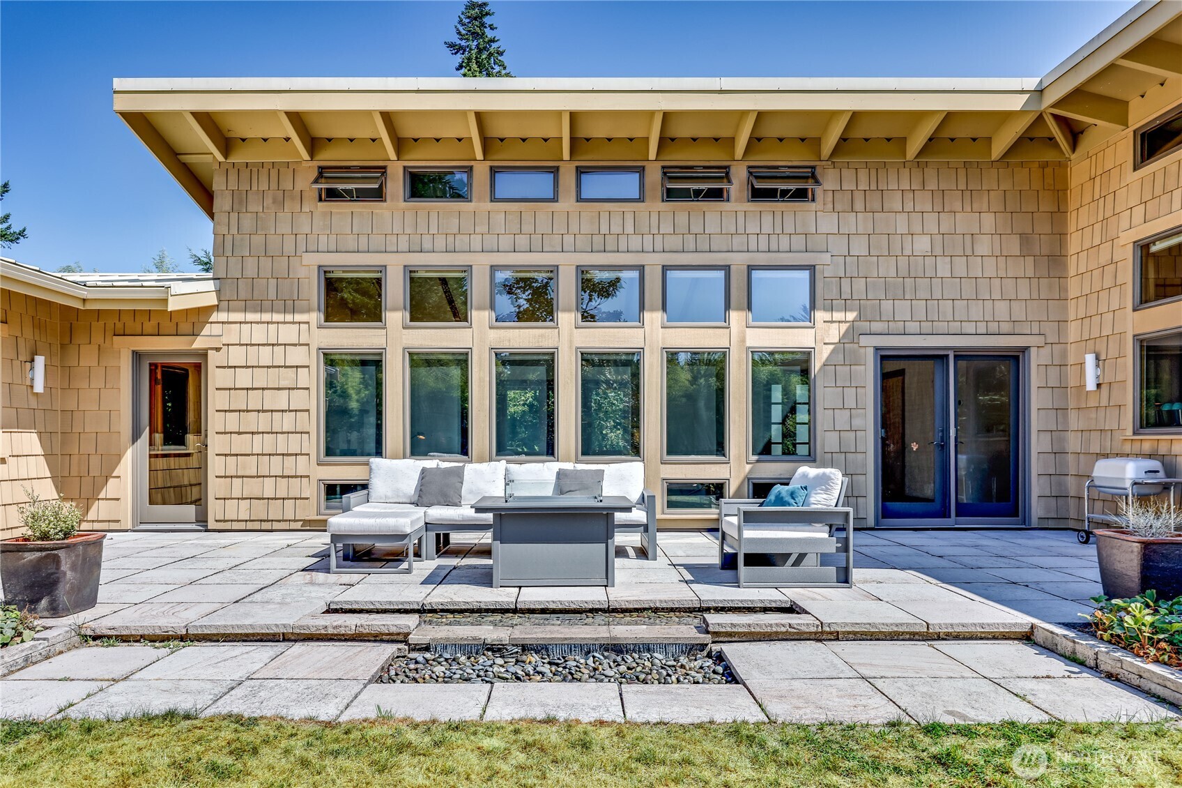 7870 Northeast Koura Farm Drive Bainbridge Island, WA 98110 - Photo 32 of 39 a building outdoor space with patio furniture
