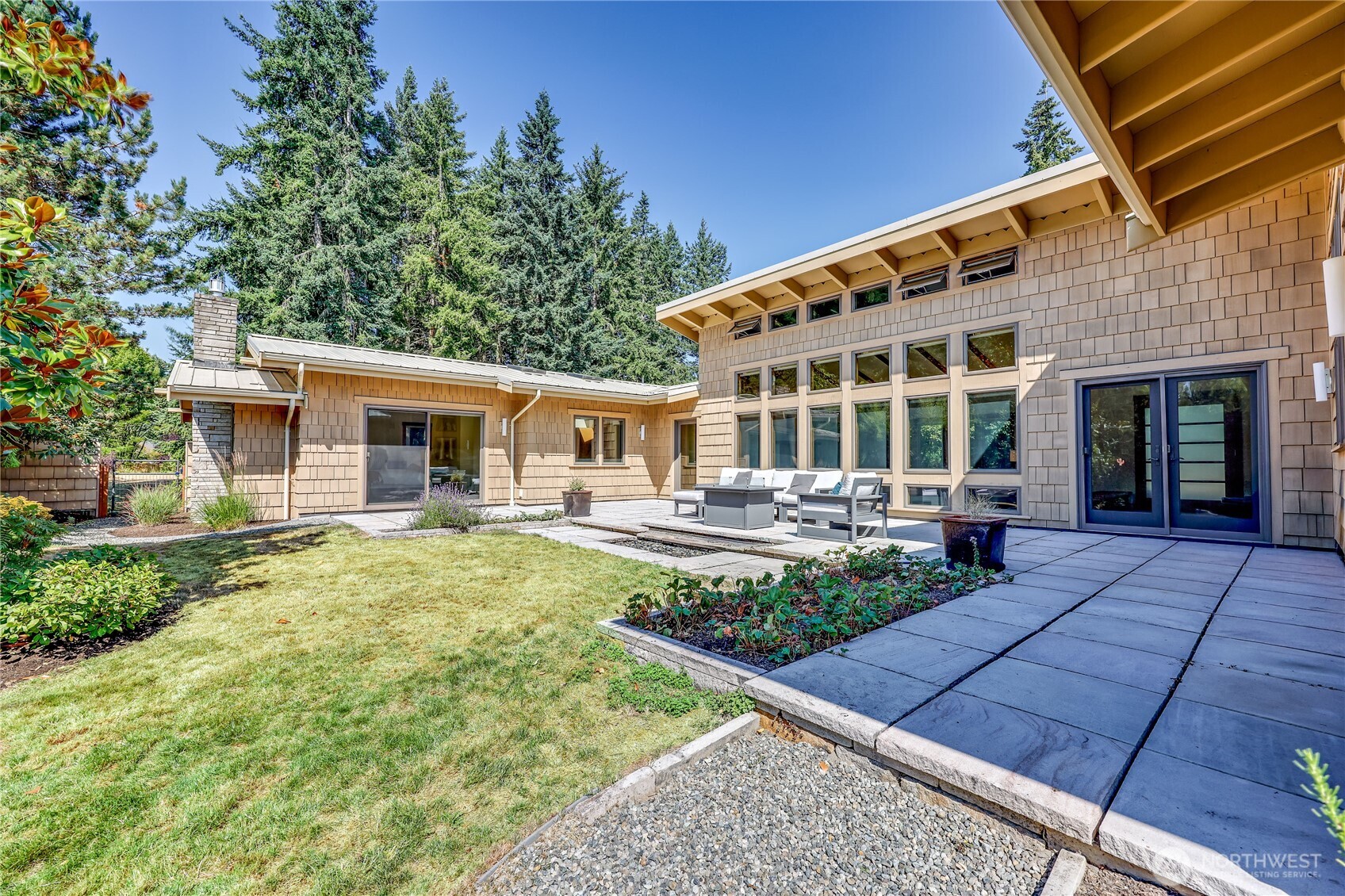 7870 Northeast Koura Farm Drive Bainbridge Island, WA 98110 - Photo 35 of 39 a view of house with backyard porch and sitting area