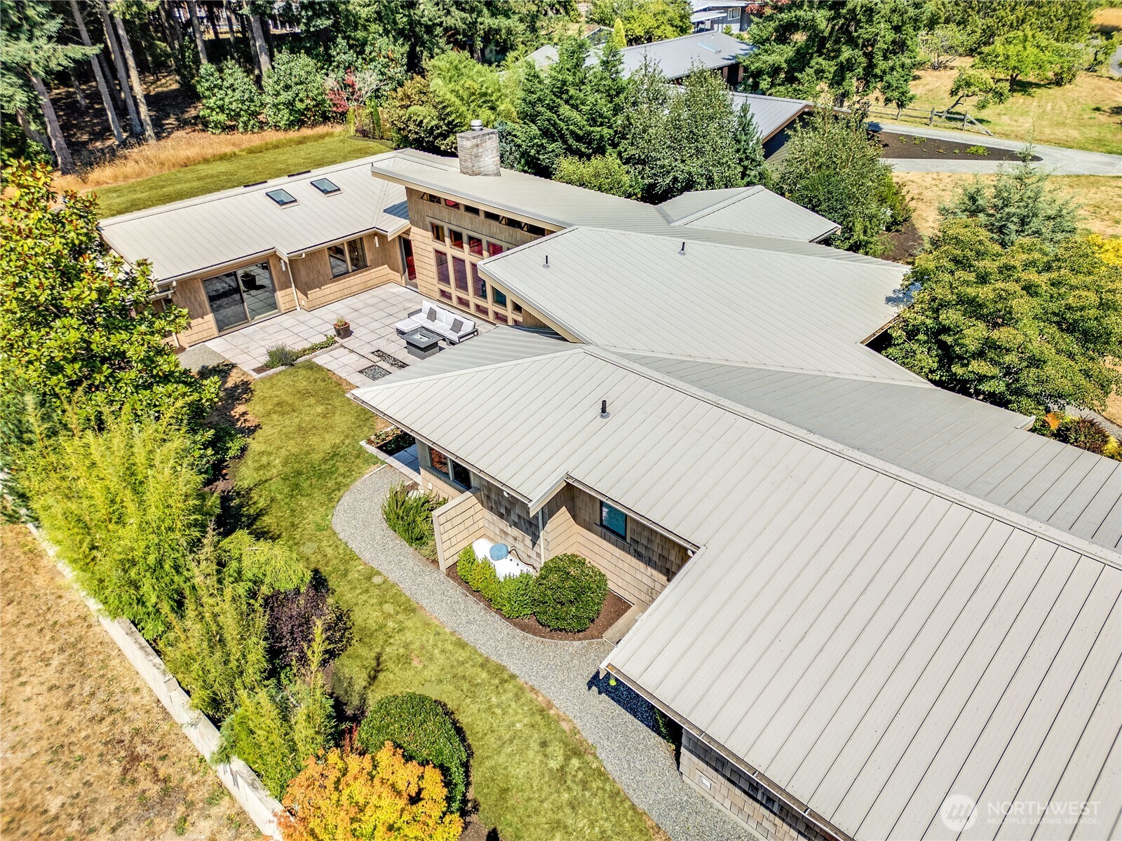 7870 Northeast Koura Farm Drive Bainbridge Island, WA 98110 - Photo 39 of 39 an aerial view of a house with swimming pool and large trees