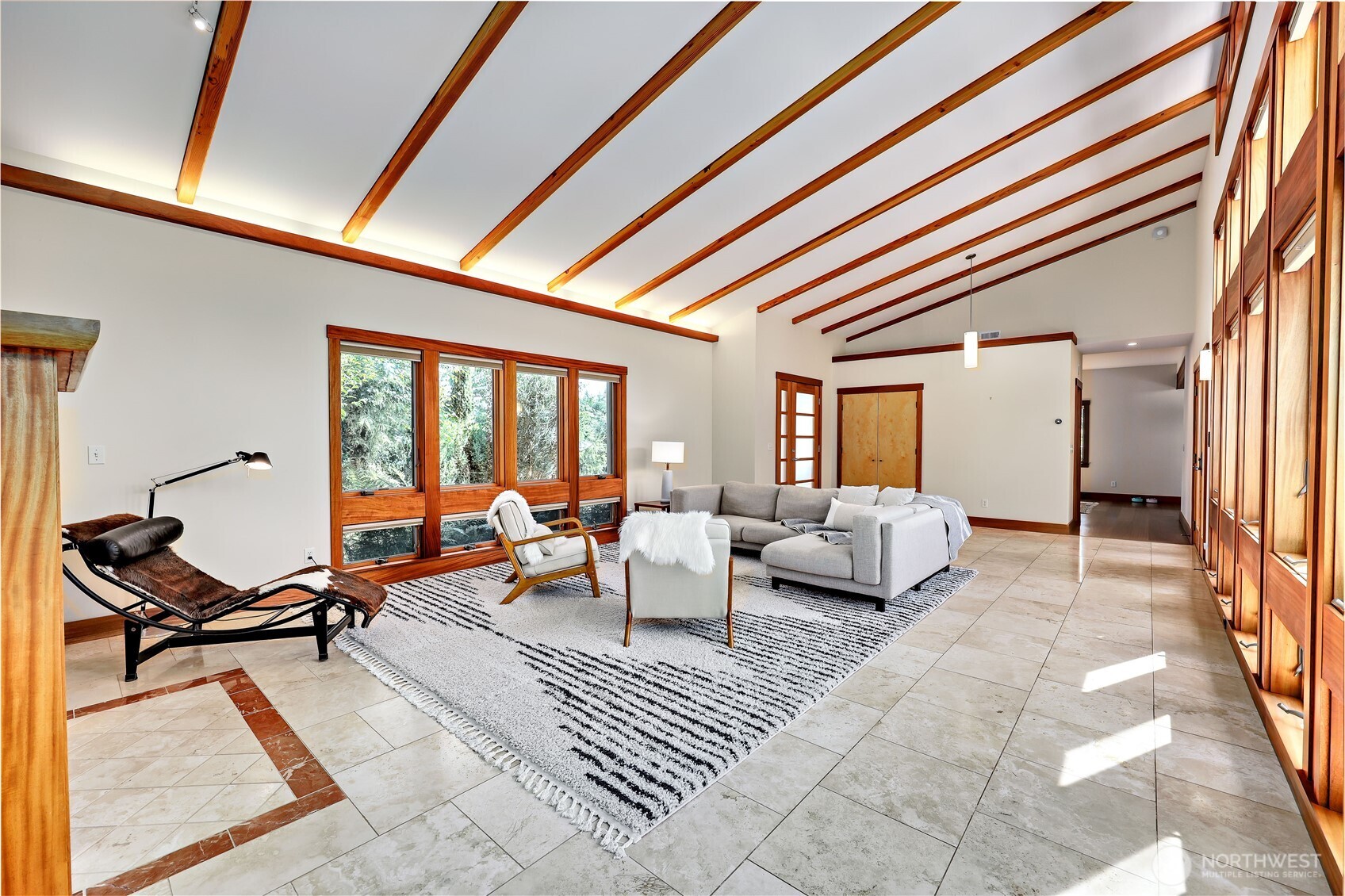 7870 Northeast Koura Farm Drive Bainbridge Island, WA 98110 - Photo 9 of 39 a living room with furniture and floor to ceiling window
