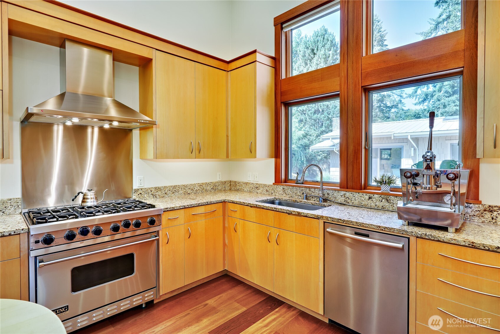 7870 Northeast Koura Farm Drive Bainbridge Island, WA 98110 - Photo 10 of 39 a kitchen with a stove a sink and wooden cabinets