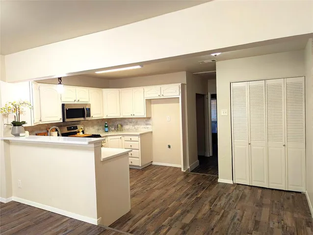 a kitchen with a refrigerator and a stove top oven