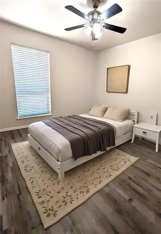 a bedroom with a large bed and a window