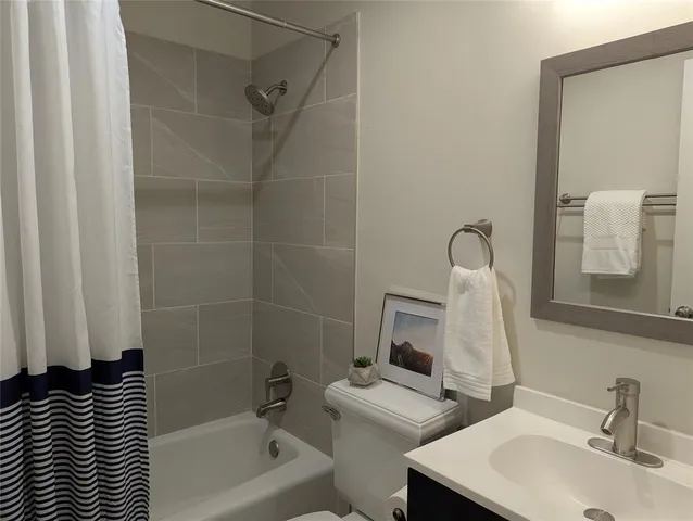 a bathroom with a bathtub and a sink