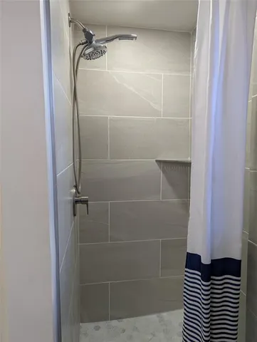 a bathroom with a glass door shower